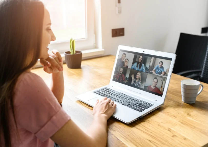 Woman sits at computer on zoom call