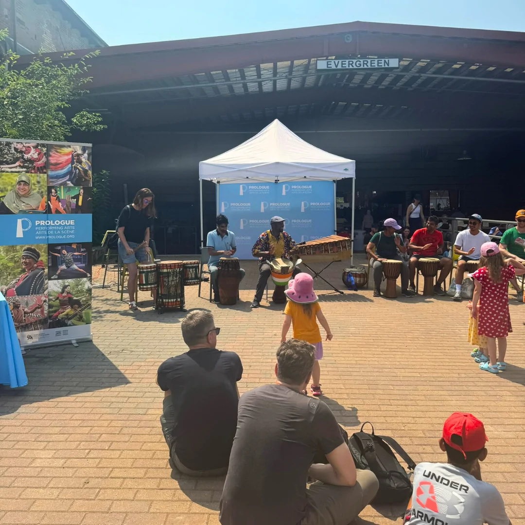 Kids dance as their parents try playing drums along with Fana Soro