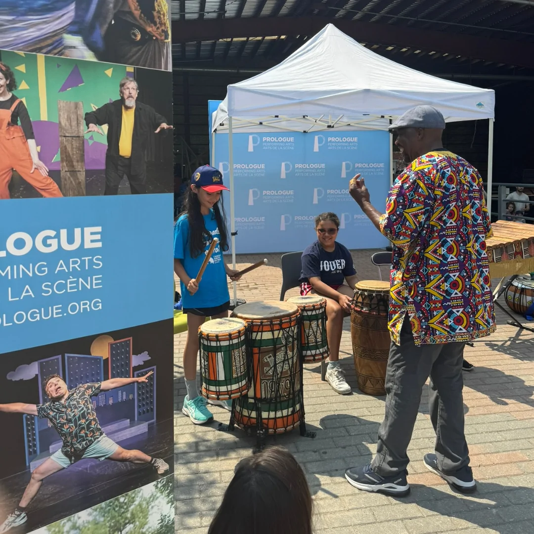 Fana shows to kids how to play drums