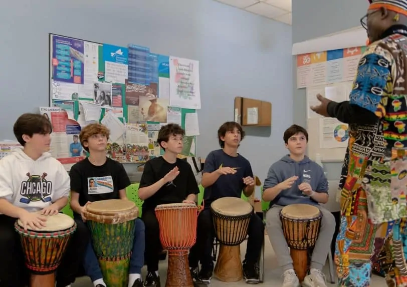 Four students playing Djembe drums in Njacko Backo's workshop