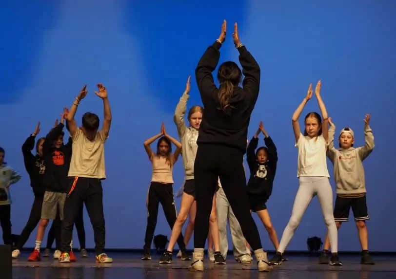 A high school student teaches a junior class during the northern residency with School of Toronto Dance Theatre