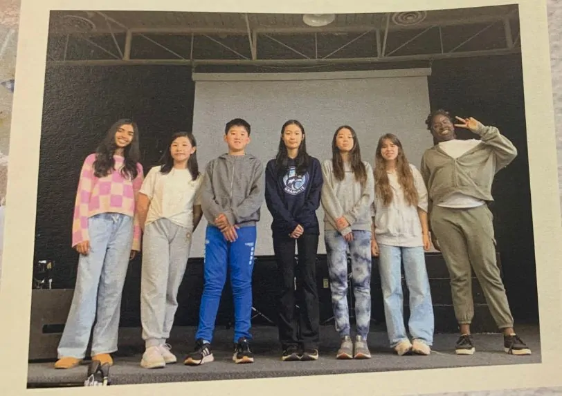 Njacko Backo performs at a school for a student audience